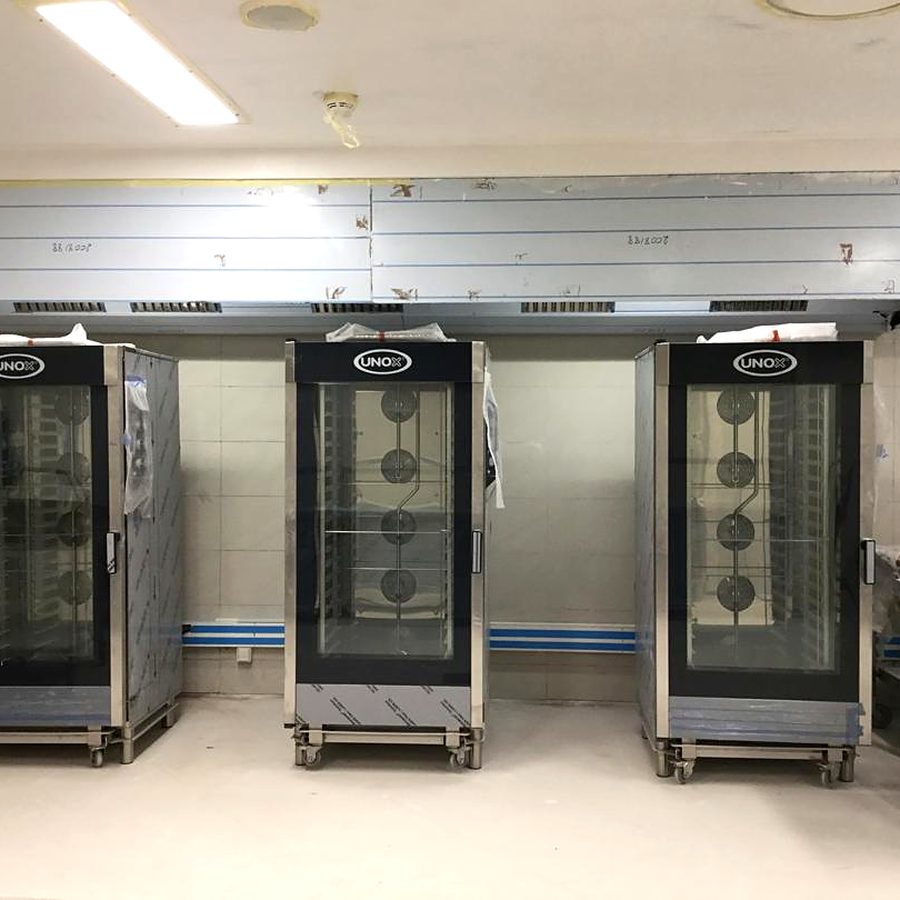 Bakery proofing and refrigeration cabinets installed under an extraction canopy